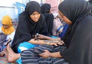 Somalian women apply henna decorations, during preparations ahead of Eid al-Fitr in Mogadishu, Somalia April 20, 2023. REUTERS/Feisal Omar