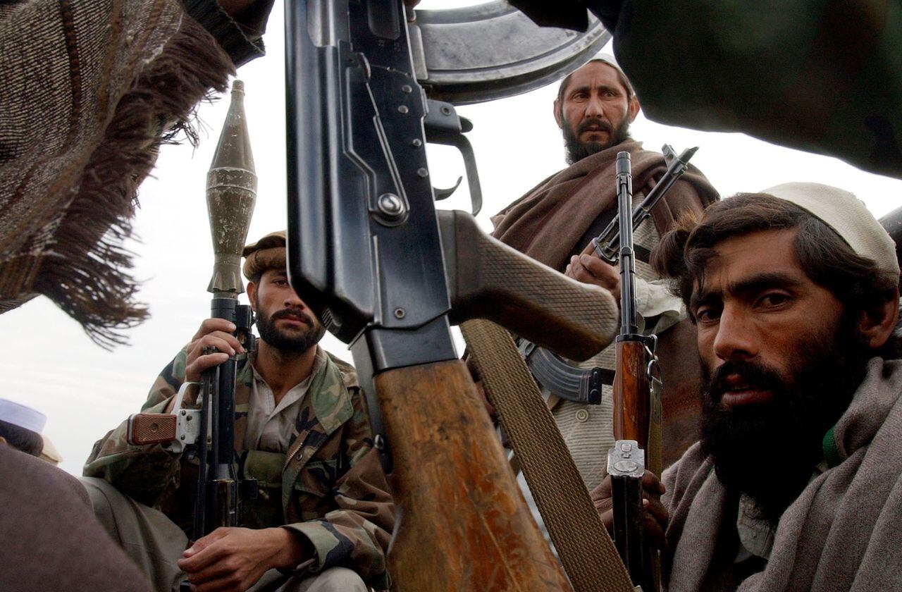 A group of Anti-Taliban fighters sit in the back of a pick-up truck as they wait to join in the pursuit of the remaining Taliban and al-Qaeda fighters. The Alliance has captured Tora Bora and some Taliban fighters, 19 of which were displayed later in the day. The remaining Taliban are said to have fled into the hills. (Craig F Walker/The Denver Post)  (Photo By Craig F. Walker/The Denver Post via Getty Images)