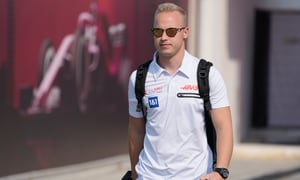 FILE - Haas driver Nikita Mazepin of Russia arrives to the Losail International Circuit in Losail, Qatar, Thursday, Nov. 18, 2021 ahead of the Qatar Formula One Grand Prix. Auto racing's international body, the FIA, said Russian drivers like Nikita Mazepin can still compete but a block on having cars in national colors would stop Mazepin's team Haas bringing back the Russian flag-stripe livery it removed during last week's testing. The Russian Grand Prix was cut from the calendar on Friday. (AP Photo/Darko Bandic, File)