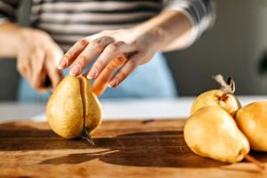 Woman cutting pear