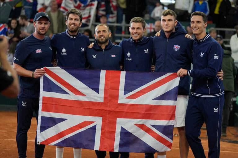 British players pose for a group photo with a Union Flag, after defeating Colombia 3-1 in matches, qualifying for the finals, at a Davis Cup qualifiers tennis tournament in Cota, Colombia, Saturday, Feb. 4, 2023. (AP Photo/Fernando Vergara)