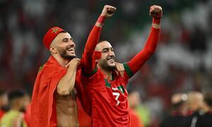 Soccer Football - FIFA World Cup Qatar 2022 - Round of 16 - Morocco v Spain - Education City Stadium, Al Rayyan, Qatar - December 6, 2022 Morocco's Hakim Ziyech celebrates with Romain Saiss after the penalty shootout as Morocco progress to the quarter finals REUTERS/Dylan Martinez