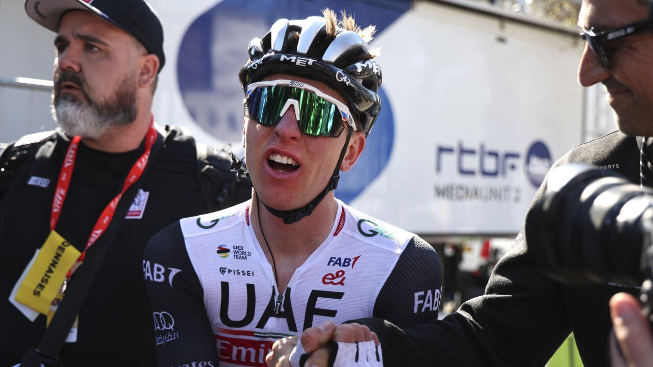 Slovenia's Tadej Pogacar of the UAE Team Emirates is congratulated after crossing the finish line to win the Belgian cycling classic and UCI World Tour race Fleche Wallonne (Walloon Arrow), in Huy, Belgium, Wednesday, April 19, 2023. (AP/Geert Vanden Wijngaert)
