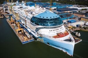 An aerial view taken on May 30, 2023 shows the construction site of the Royal Caribbean's new ship 'Icon of the Seas' at the Turku shipyard in Finland's southwest coast. With cruise bookings seeing a resurgence after the Covid pandemic saw luxury liners mothballed, a Finnish shipyard is putting the final touches on what will be the world's largest cruise ship. Royal Caribbean's luxurious new vessel Icon of the Seas is nearing completion in the Turku shipyard on Finland's southwestern coast, its maiden voyage scheduled for January 2024. (Photo by Jonathan NACKSTRAND / AFP)