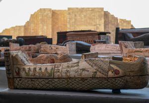 A picture shows wooden sarcophagi on display during the unveiling of an ancient treasure trove of more than a 100 intact sarcophagi, at the Saqqara necropolis 30 kms south of the Egyptian capital Cairo, on November 14, 2020. - Egypt announced the discovery of an ancient treasure trove of more than a 100 intact sarcophagi, the largest such find this year. The sealed wooden coffins, unveiled on site amid fanfare, belonged to top officials of the Late Period and the Ptolemaic period of ancient Egypt. They were found in three burial shafts at depths of 12 metres (40 feet) in the sweeping Saqqara necropolis south of Cairo. (Photo by Ahmed HASAN / AFP)