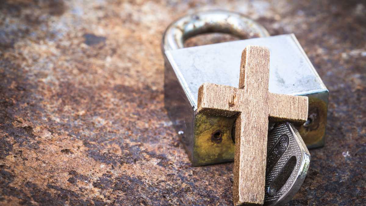 image of the metal lock and key with wooden cross on old rusty metal background can use for christian symbol show meaning Jesus is the key to heaven or the key to solve the spiritual problem