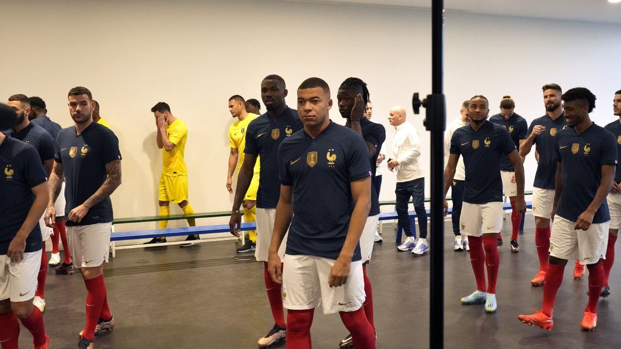CORRECTS DATE - France's soccer team player Kylian Mbappe, center, leaves the photo group session, at Clairefontaine training center, south of Paris, Tuesday, Nov. 15, 2022. Defending champion France opens against Australia on Nov. 22, and the squad will fly to Qatar on Wednesday. (AP/Thibault Camus)
