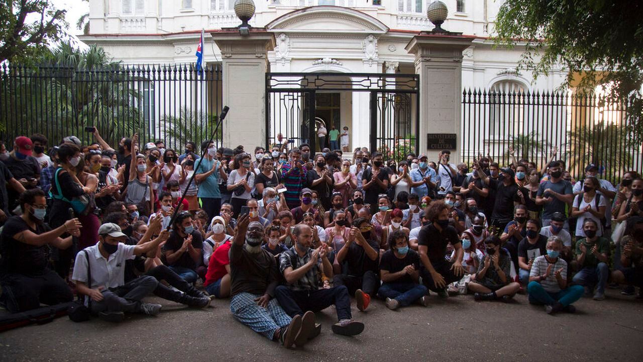 Young artists protest in front of the doors of the Ministry of Culture, in Havana, Cuba, Friday, Nov. 27, 2020. Dozens of Cuban artists demonstrated against the police evicting a group who participated in a hunger strike. (AP Photo/Ismael Francisco)