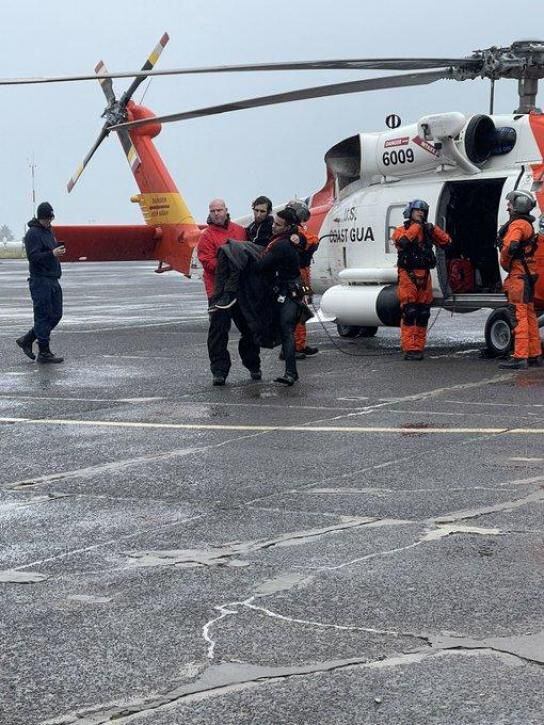 Momentos en que la Guardia Costera de EE. UU. rescata a pasajero de un barco golpeado por una gran ola.