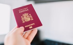 Hand holding a Spanish passport.