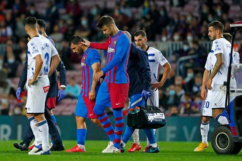 Barcelona's Sergio Aguero, second left, leaves the pitch injured during the La Liga soccer match between Barcelona and Alaves at the Camp Nou stadium in Barcelona, Spain Saturday, Oct. 30, 2021. (AP Photo/Joan Monfort)