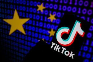The TikTok logo is seen on a mobile with cyber code displayed on the screen in Brussels, Belgium on March 21, 2023. (Photo Illustration by Jonathan Raa/NurPhoto via Getty Images)
