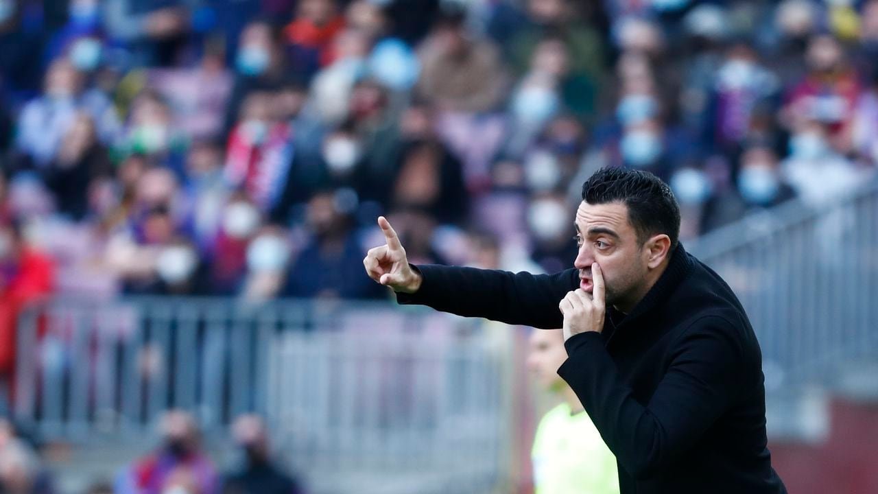 Barcelona's head coach Xavi Hernandez gives instructions from the side line during a Spanish La Liga soccer match between FC Barcelona and Atletico Madrid at the Camp Nou stadium in Barcelona, Spain, Sunday, Feb. 6, 2022. (AP Photo/Joan Monfort)