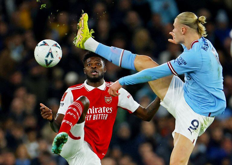 Soccer Football - FA Cup - Fourth Round - Manchester City v Arsenal - Etihad Stadium, Manchester, Britain - January 27, 2023 Arsenal's Thomas Partey in action with Manchester City's Erling Braut Haaland REUTERS/Molly Darlington