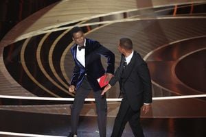 HOLLYWOOD, CA - March 27, 2022.    Chris Rock and Will Smith onstage during the show  at the 94th Academy Awards at the Dolby Theatre at Ovation Hollywood on Sunday, March 27, 2022.  (Myung Chun / Los Angeles Times via Getty Images)