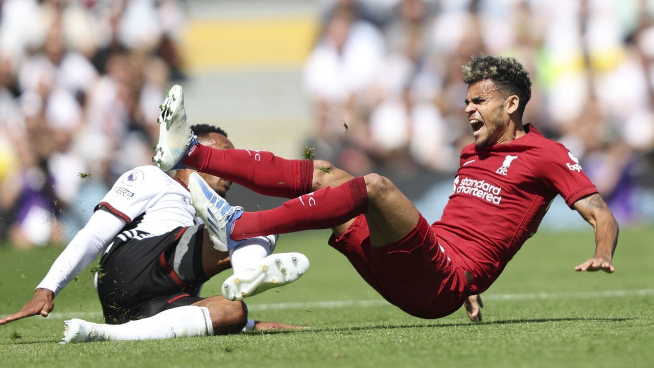 Liverpool's Luis Diaz, right, is tackled by Fulham's Kenny Tete vie for the ball during the English Premier League soccer match between Fulham and Liverpool at Craven Cottage stadium in London, Saturday, Aug. 6, 2022. (AP/Ian Walton)