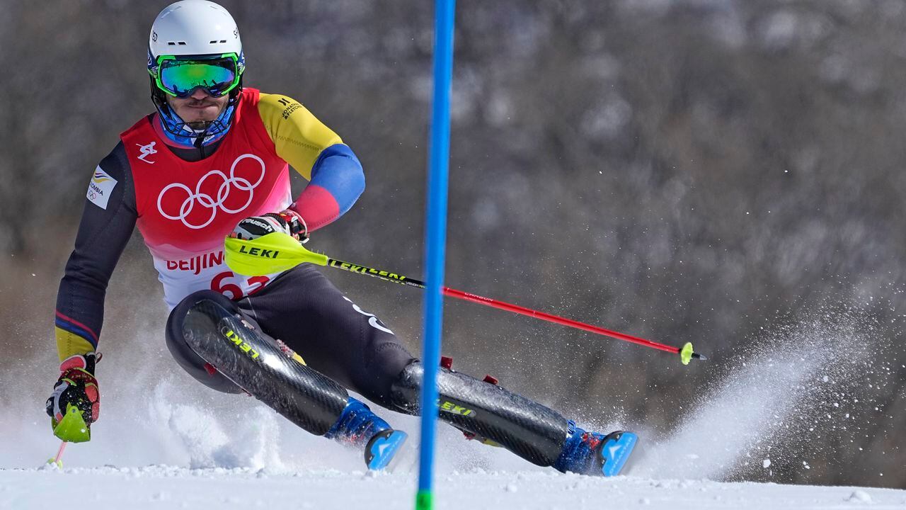 Michael Poettoz, of Colombia passes a gate during the first run of the men's slalom at the 2022 Winter Olympics, Wednesday, Feb. 16, 2022, in the Yanqing district of Beijing. (AP Photo/Robert F. Bukaty)