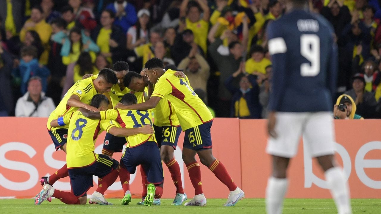 Colombian players celebrate after Ecuador scored an own goal during the South American U-20 championship football match at El Campin stadium in Bogota, Colombia on February 6, 2023. (Photo by DANIEL MUNOZ / AFP)