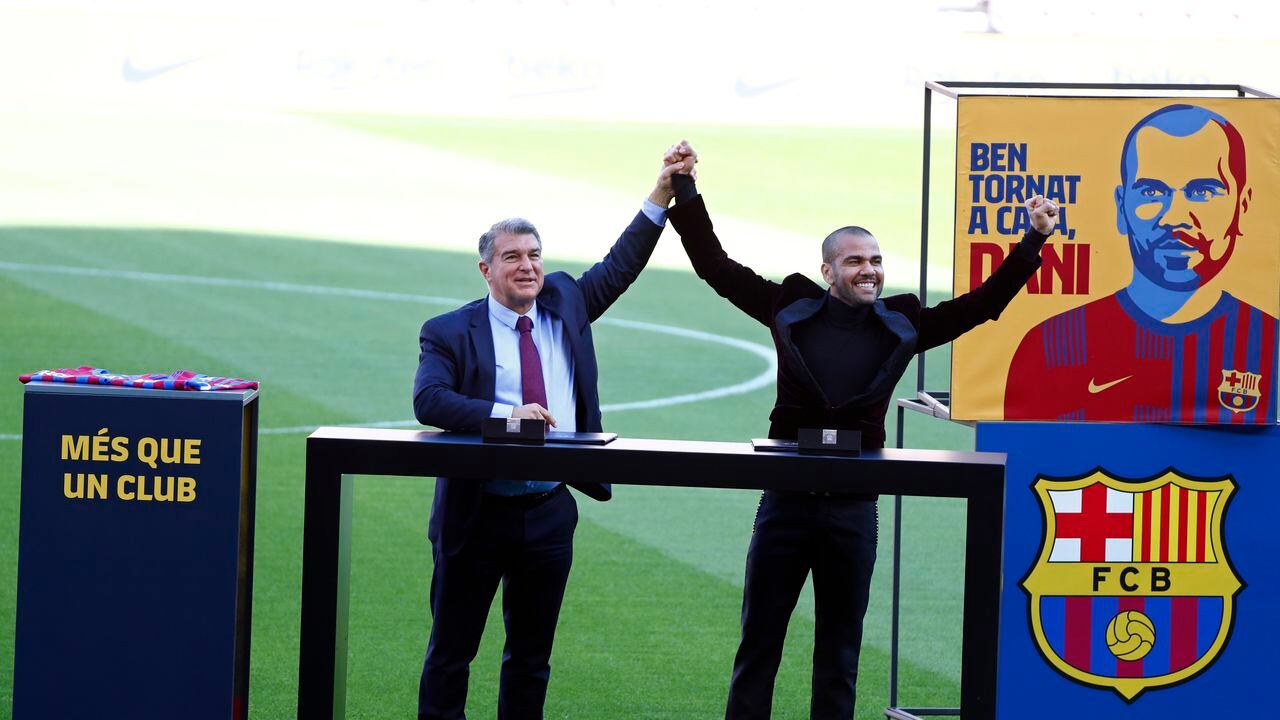 Dani Alves, right and Barcelona club President Joan Laporta react during Alves' official presentation for FC Barcelona in Barcelona, Spain, Wednesday, Nov. 17, 2021. Veteran full back Dani Alves has returned to Barcelona at age 38 to finish out the rest of the season with the team. Alves formed part of Barcelona's greatest era from 2008 to 2016 and helped it win 23 titles, including three Champions League trophies and six Spanish leagues.(AP Photo/Joan Monfort)