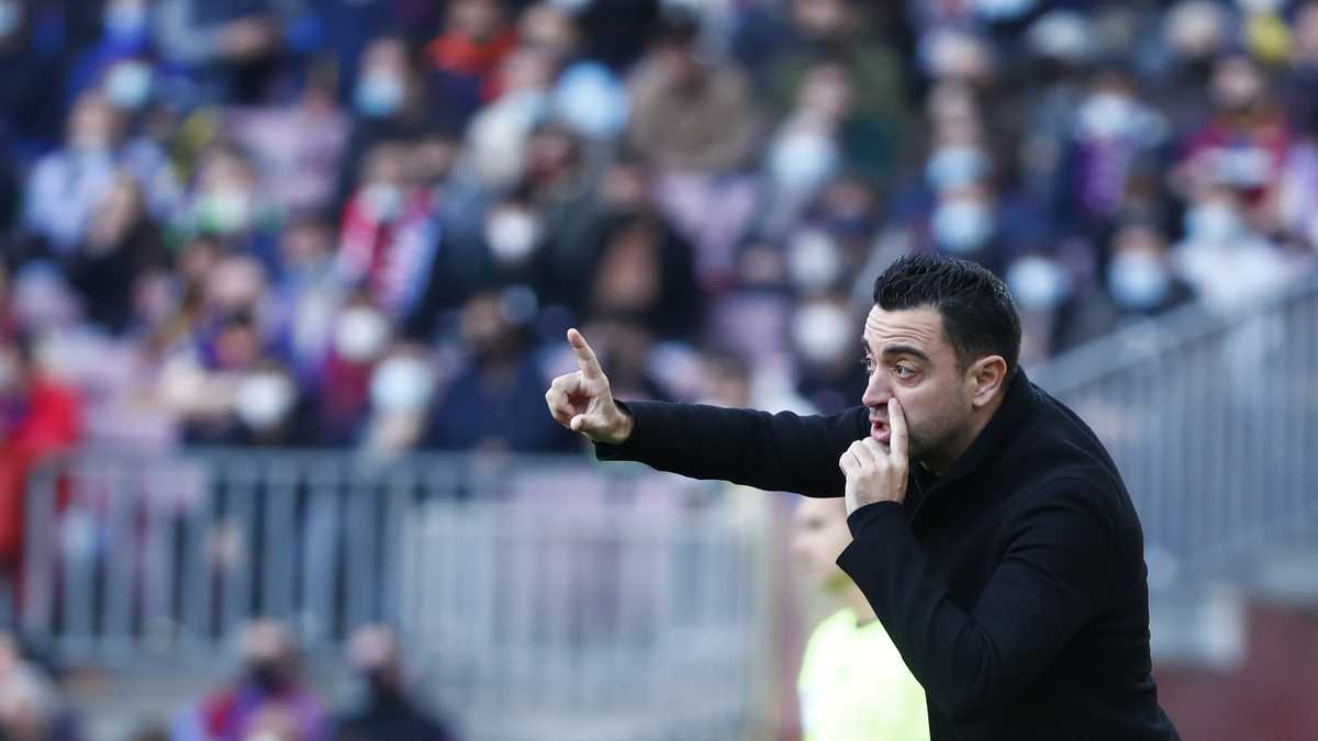 Barcelona's head coach Xavi Hernandez gives instructions from the side line during a Spanish La Liga soccer match between FC Barcelona and Atletico Madrid at the Camp Nou stadium in Barcelona, Spain, Sunday, Feb. 6, 2022. (AP Photo/Joan Monfort)