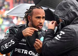 Mercedes driver Lewis Hamilton of Britain, left, speaks with a member of his crew prior to the Formula One Grand Prix at the Spa-Francorchamps racetrack in Spa, Belgium, Sunday, Aug. 29, 2021. (John Thys, Pool Photo via AP)
