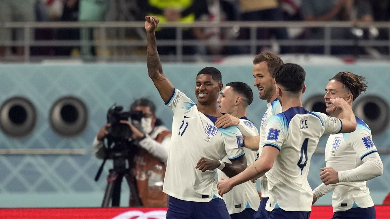 England's Marcus Rashford celebrates with teammates after scoring his side's fifth goal during the World Cup group B soccer match between England and Iran at the Khalifa International Stadium in Doha, Qatar, Monday, Nov. 21, 2022. (AP Photo/Frank Augstein)