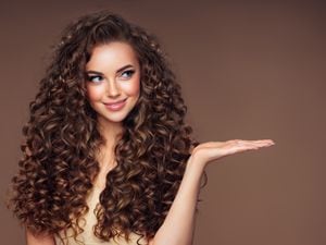 Beautiful woman with voluminous curly hairstyle