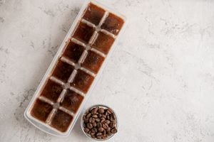 Cubes of frozen coffee in the form of ice with coffee beans. Cocktail ingredient.
