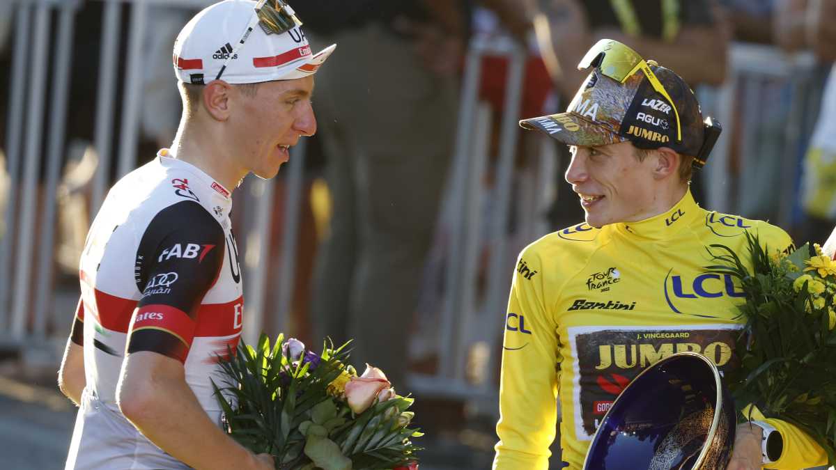 Tour de France winner Denmark's Jonas Vingegaard, wearing the overall leader's yellow jersey speaks with Slovenia's Tadej Pogacar, wearing the best young rider's white jersey, after the twenty-first stage of the Tour de France cycling race over 116 kilometers (72 miles) with start in Paris la Defense Arena and finish on the Champs Elysees in Paris, France, Sunday, July 24, 2022. (AP/Etienne Garnier/Pool)