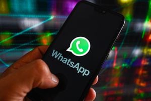 POLAND - 2023/07/06: In this photo illustration, the WhatsApp logo displayed on a smartphone with stock market percentages in the background. (Photo Illustration by Omar Marques/SOPA Images/LightRocket via Getty Images)