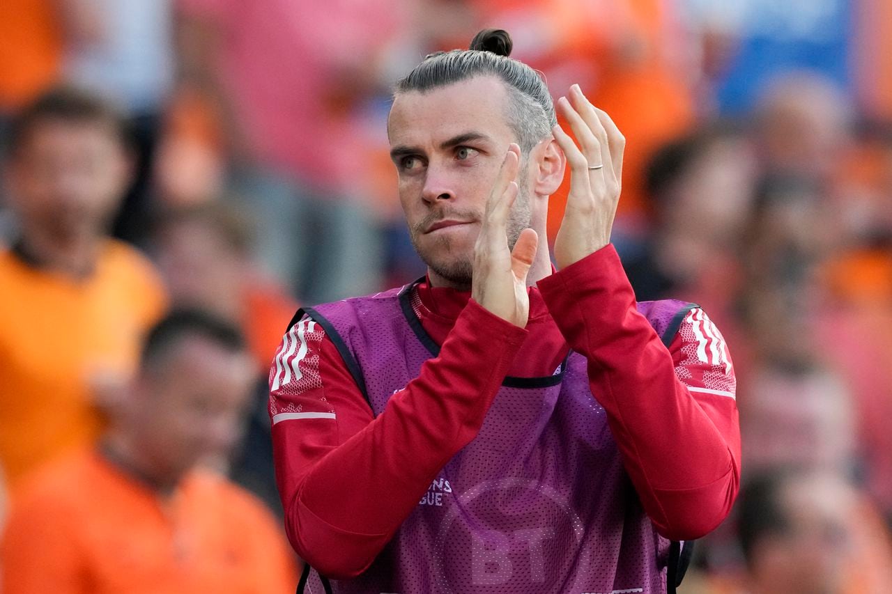 Wales' Gareth Bale warms up for a possible substitution during the UEFA Nations League soccer match between the Netherlands and Wales at De Kuip stadium in Rotterdam, Netherlands, Tuesday, June 14, 2022. (AP Photo/Peter Dejong)