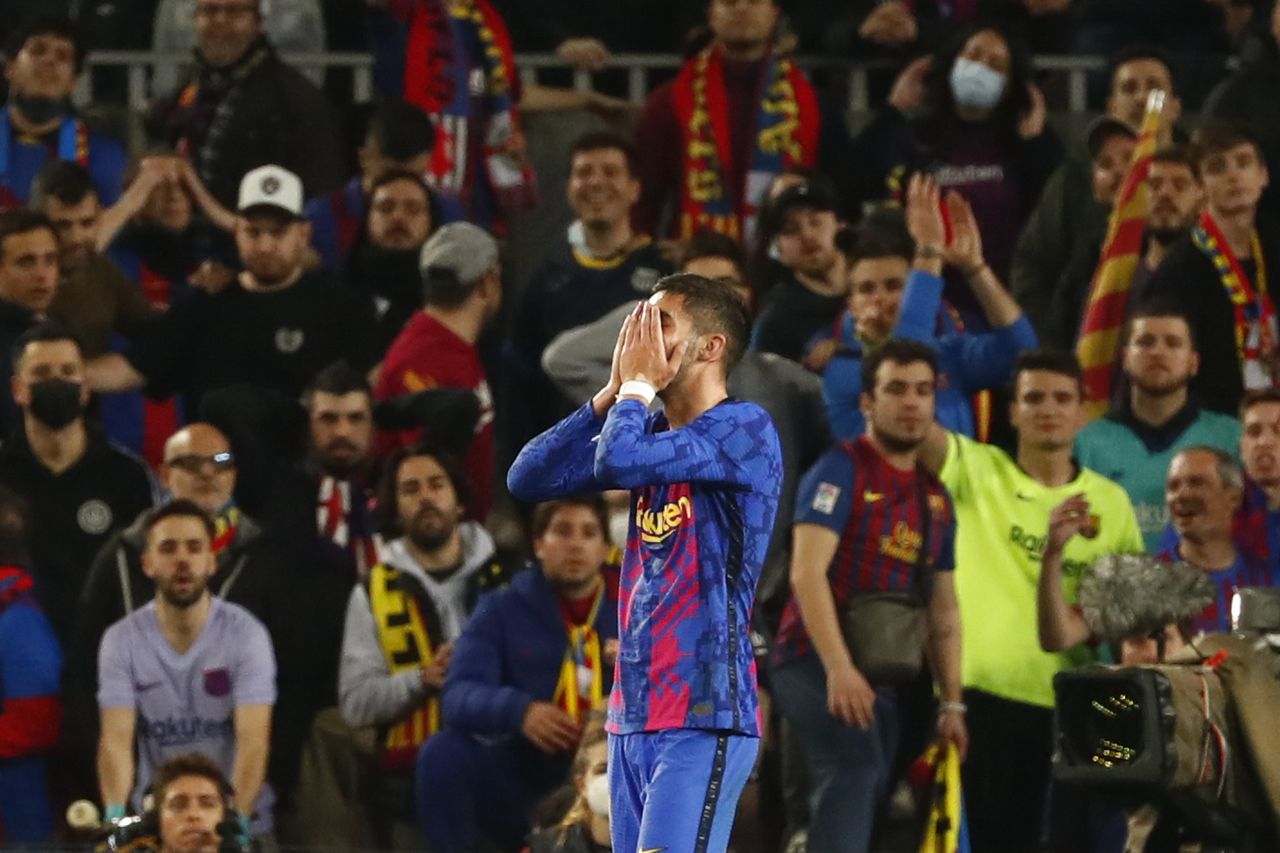 Barcelona's Ferran Torres covers his face after missing a scoring chance during the Europa League soccer match between Barcelona and Napoli in Barcelona, Spain, Thursday, Feb. 17, 2022. (AP Photo/Joan Monfort)