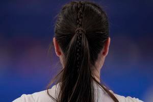 Britain's Hailey Duff wears a bread in her hair during a women's curling match against China at the Beijing Winter Olympics Wednesday, Feb. 16, 2022, in Beijing. (AP Photo/Brynn Anderson)