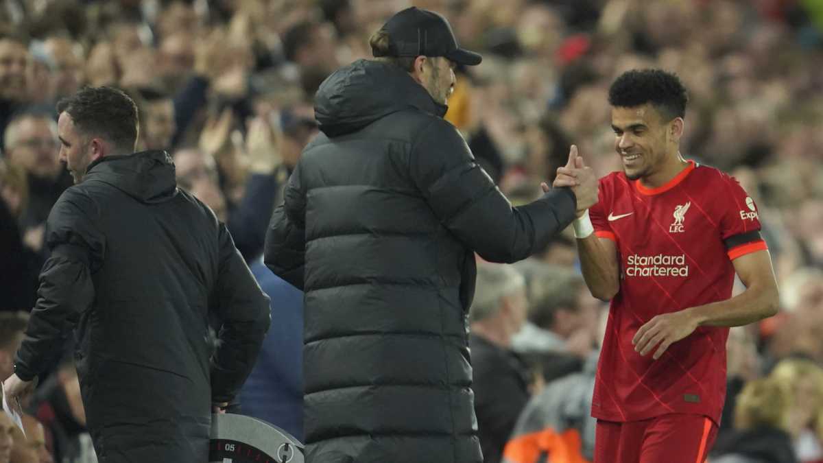Liverpool's Luis Diaz, right, is congratulated by his manager Jurgen Klopp during the English Premier League soccer match between Liverpool and Manchester United at Anfield stadium in Liverpool, England, Tuesday, April 19, 2022. (AP/Jon Super)
