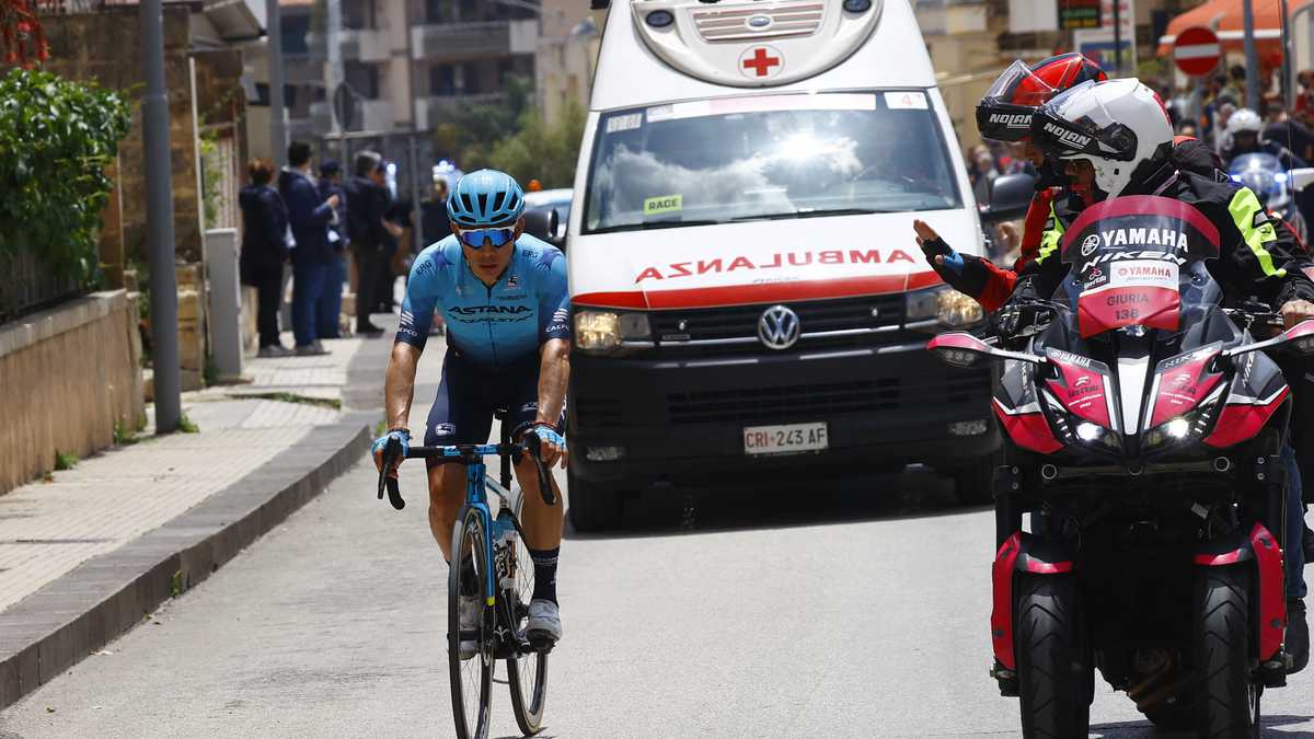 Team Astana's Colombian rider Miguel Angel Lopez rides by an Italian Red Cross ambulance in the first kilometers of the 4th stage of the Giro d'Italia 2022 cycling race, 172 kilometers between Avola and Etna-Nicolosi, Sicily, on May 10, 2022. (Photo by Luca Bettini / AFP)