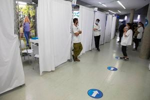 Israeli medics wait  during an event to encourage the vaccination of young Israelis at a vaccination center in the Israeli city of Holon near Tel Aviv, Monday, Feb. 15, 2021. (AP Photo/Sebastian Scheiner)