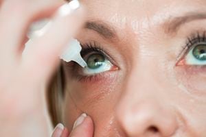Woman usind eyedropper...applying eye drops