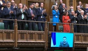 A video grab from footage broadcast by the UK Parliament's Parliamentary Recording Unit (PRU) shows MPs giving a standing ovation to Ukraine's President Volodymyr Zelensky after he speaks to them by live video-link in the House of Commons, in London, on March 8, 2022. (Photo by PRU / AFP) / RESTRICTED TO EDITORIAL USE - MANDATORY CREDIT "AFP PHOTO / PRU " - NO MARKETING - NO ADVERTISING CAMPAIGNS - DISTRIBUTED AS A SERVICE TO CLIENTS