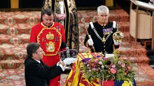 The Crown Jeweller, left, removes the Imperial State Crown from the coffin of Britain's Queen Elizabeth II during a committal service at St George's Chapel, Windsor Castle, in Windsor, England, Monday, Sept. 19, 2022. (Joe Giddens/Pool Photo via AP)