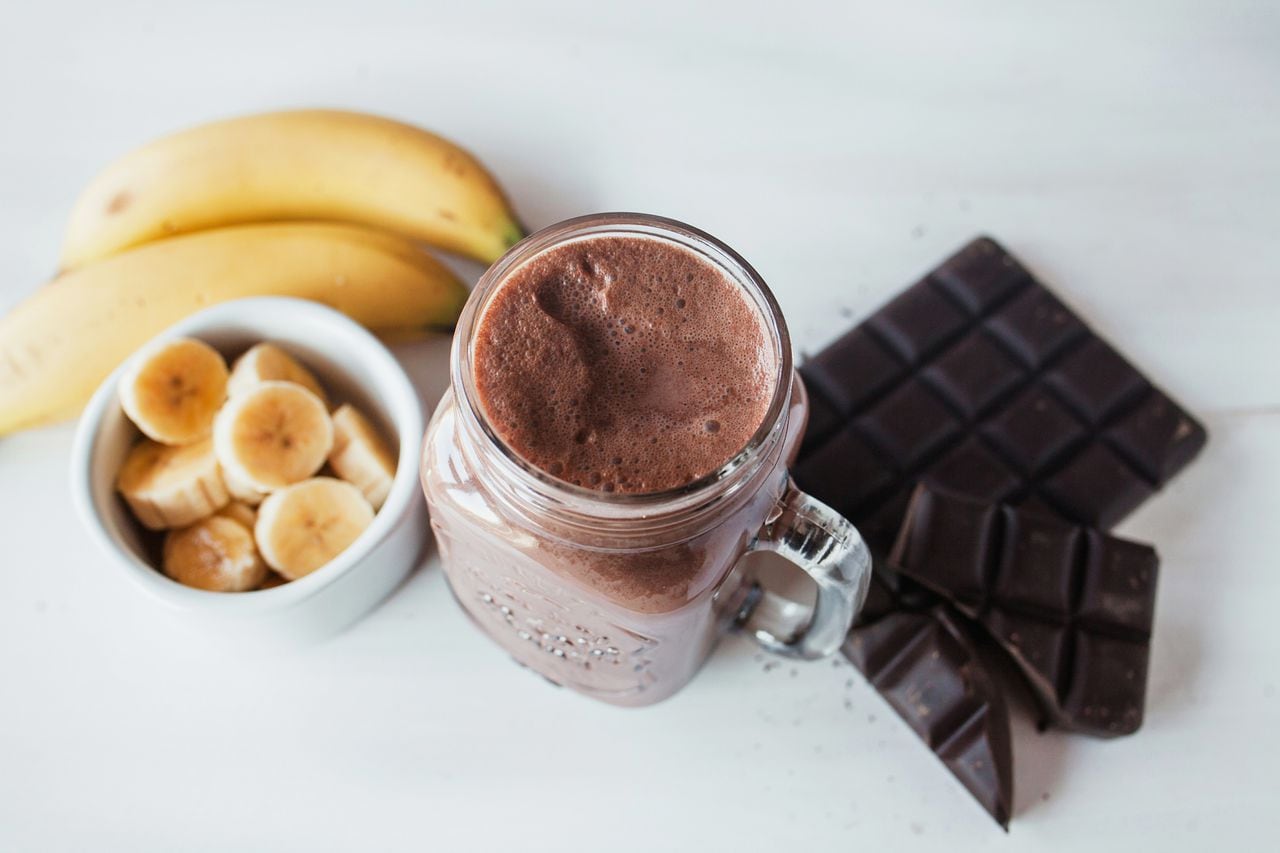 Banana and chocolate smoothie in the glass jar milkshakes, natural and organic drink