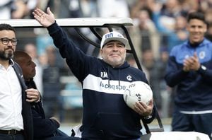 (FILES) In this file photo taken on September 08, 2019 Argentine former football star and new coach of Gimnasia y Esgrima La Plata Diego Armando Maradona waves upon arrival for his first training session at El Bosque stadium, in La Plata, Buenos Aires province, Argentina. - Next November 25, 2021 marks the first anniversary of Diego Maradona's death. (Photo by ALEJANDRO PAGNI / AFP)