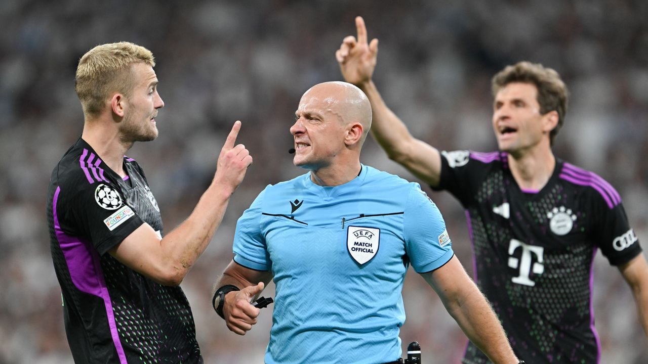 08 May 2024, Spain, Madrid: Soccer: Champions League, Real Madrid - Bayern Munich, knockout round, semi-final, second leg, Santiago Bernabeu. Referee Szymon Marciniak (M) confirms the offside goal by Matthijs de Ligt (l) of Munich. Photo: Peter Kneffel/dpa (Photo by Peter Kneffel/picture alliance via Getty Images)