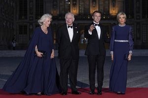 French President Emmanuel Macron, center right, his wife Brigitte Macron, right, Britain's King Charles III, center left, and Queen Camilla arrive for a state dinner, at the Chateau de Versailles, west of Paris, Wednesday, Sept. 20, 2023. King Charles III of the United Kingdom starts a three-day state visit to France on Wednesday meant to highlight the friendship between the two nations with great pomp, after the trip was postponed in March amid widespread demonstrations against President Emmanuel Macron's pension changes. (AP Photo/Christophe Ena)