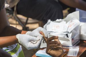 In mid January 2015, a three day period of excessive rain brought unprecedented floods to the small poor African country of Malawi. It displaced nearly quarter of a million people, devastated 64,000 hectares of land, and killed several hundred people. This shot shows A Medicin Sans Frontieres clinic in Makhanga blood testing local people for malaria, many proving positive for the disease as a result of the drying up flood waters providing ideal breeding grounds for mosquitoes.