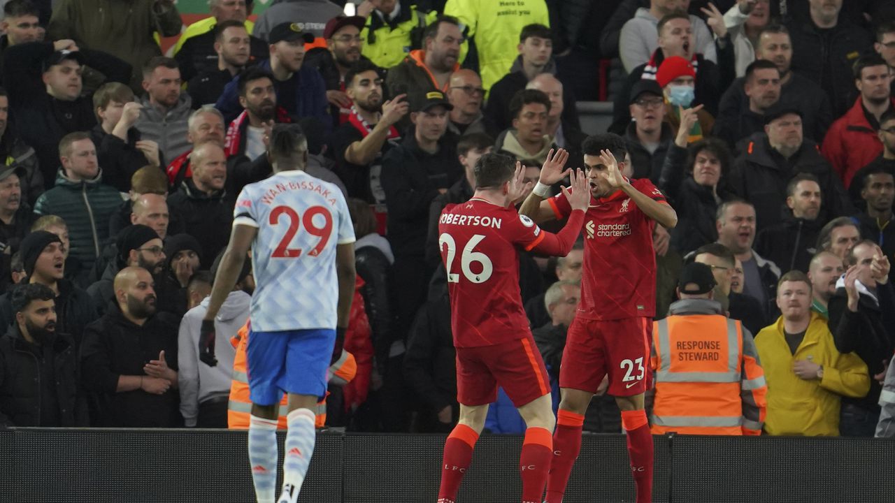 Liverpool's Luis Diaz, right, celebrates after scoring his side's opening goal during the English Premier League soccer match between Liverpool and Manchester United at Anfield stadium in Liverpool, England, Tuesday, April 19, 2022. (AP Photo/Jon Super)