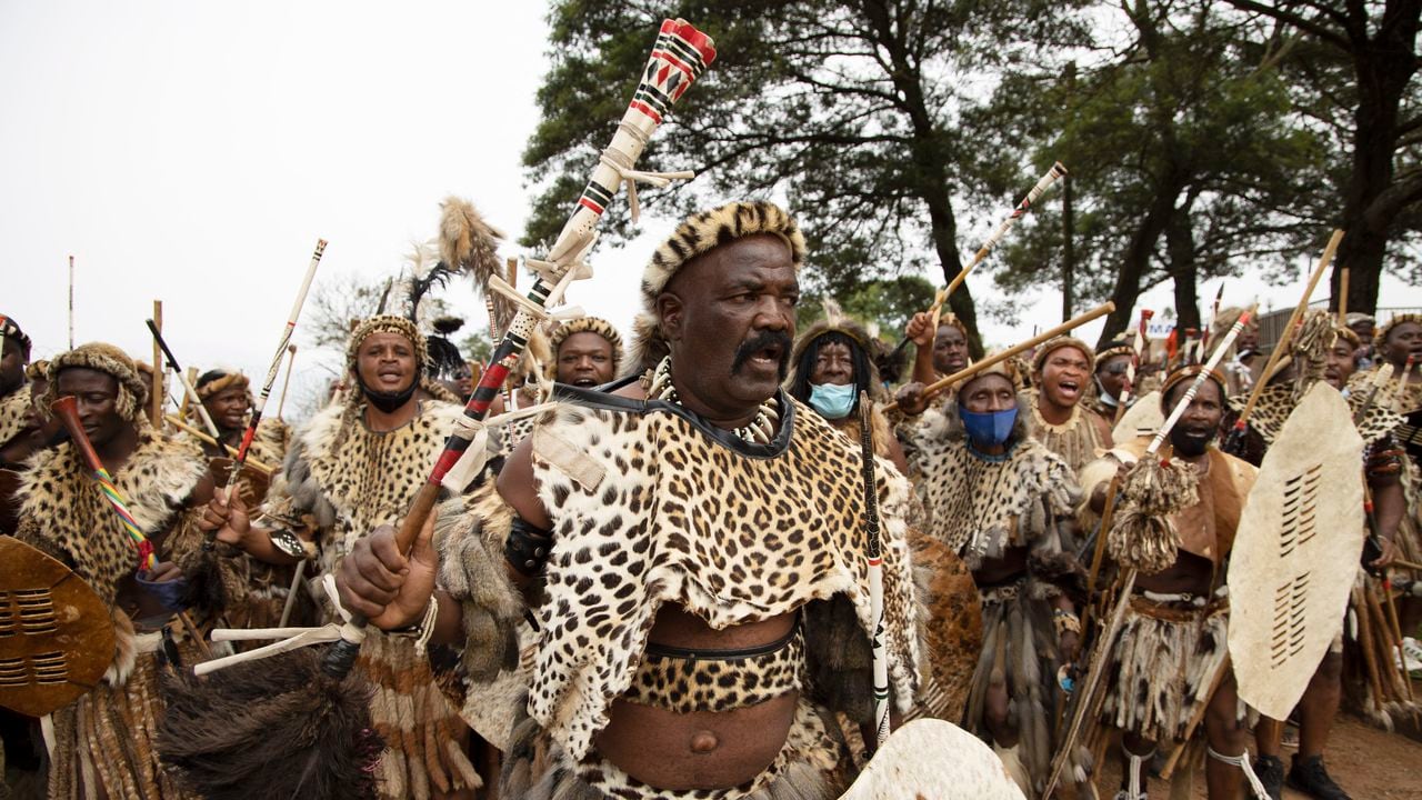 Amabutho (Zulu regiments) make their way to the mortuary to receive the body of King Goodwill Zwelithini from in Nongoma, KwaZulu Natal on March 17, 2021. - King Goodwill Zwelithini died on March 12, 2021 in the eastern city of Durban, aged 72, after weeks of treatment for a diabetes-related illness.