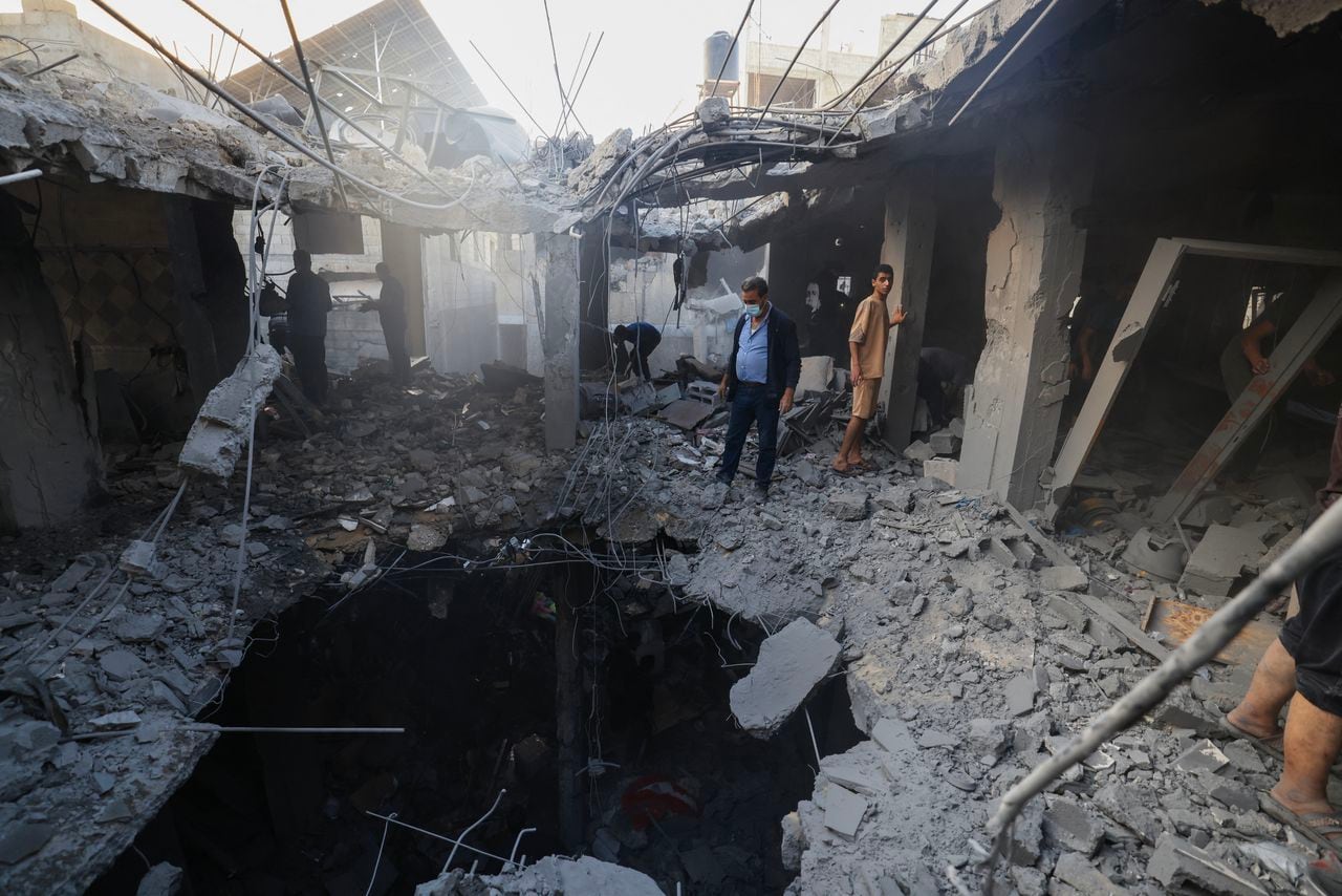 Los palestinos buscan sobrevivientes entre los escombros de un edificio después del bombardeo israelí en Khan Yunis, en el sur de la Franja de Gaza.
