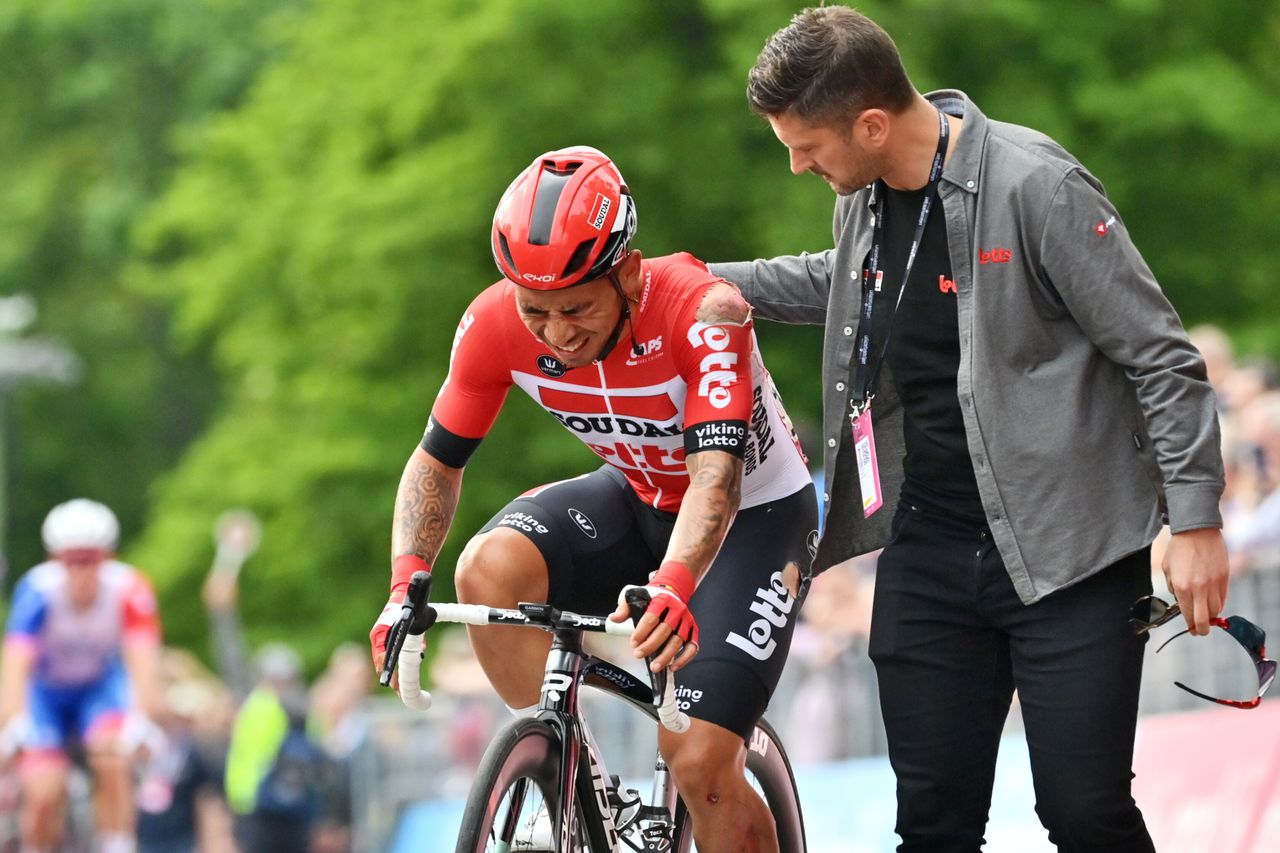 Australia's Caleb Ewan is assisted as he approaches the finish line after falling down during the opening stage of the Giro d'Italia cycling race, from Budapest to Visegrad, Hungary, Friday, May 6, 2022. (Massimo Paolone/LaPresse via AP)