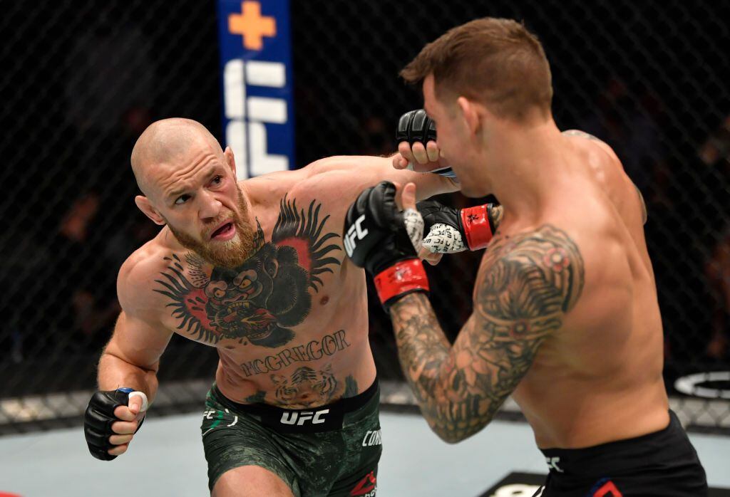 ABU DHABI, UNITED ARAB EMIRATES - JANUARY 23: In this handout image provided by the UFC, (L-R) Conor McGregor of Ireland punches Dustin Poirier in a lightweight fight during the UFC 257 event inside Etihad Arena on UFC Fight Island on January 23, 2021 in Abu Dhabi, United Arab Emirates. (Photo by Jeff Bottari/Zuffa LLC via Getty Images)