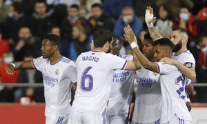 Real Madrid players celebrate after Vinicius Junior, 4th left, scored the opening goal during a Spanish La Liga soccer match between Mallorca and Real Madrid in Palma de Mallorca, Spain, Monday, March 14, 2022. (AP/Francisco Ubilla)